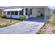 White mobile home with carport and landscaped front yard at 6734 Kensington Ne Dr, Winter Haven, FL 33881
