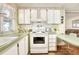 Efficient kitchen with white appliances and light-colored cabinets at 6734 Kensington Ne Dr, Winter Haven, FL 33881