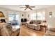Living room with couches, chairs, and access to sunroom at 6734 Kensington Ne Dr, Winter Haven, FL 33881