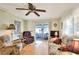 Spacious living room with hardwood floors and view of sunroom at 6734 Kensington Ne Dr, Winter Haven, FL 33881