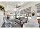 Sunroom with seating, dining area, and screened windows at 6734 Kensington Ne Dr, Winter Haven, FL 33881