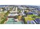 Aerial view showcasing the neighborhood, swimming pool, tennis and basketball courts, and verdant landscaping at 4676 Grandview Glen Dr, Auburndale, FL 33823