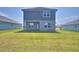 A two-story house in the backyard has a covered porch and neatly manicured lawn at 4676 Grandview Glen Dr, Auburndale, FL 33823