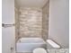 Bathroom features a tiled shower over tub, white toilet, and neutral color scheme at 4676 Grandview Glen Dr, Auburndale, FL 33823