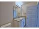 Bathroom boasts a granite countertop, modern lighting, and white cabinets at 4676 Grandview Glen Dr, Auburndale, FL 33823
