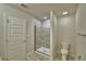 Bathroom featuring a glass-enclosed shower with tile surround, toilet and towel rack at 4676 Grandview Glen Dr, Auburndale, FL 33823