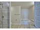 Well-lit bathroom featuring a glass-enclosed shower and separate soaking tub at 4676 Grandview Glen Dr, Auburndale, FL 33823