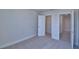 Bedroom showcasing a closet and an open doorway to the hallway, carpeted flooring at 4676 Grandview Glen Dr, Auburndale, FL 33823