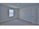 Bedroom features neutral carpet, a window, and closet at 4676 Grandview Glen Dr, Auburndale, FL 33823