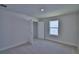 Bedroom features neutral carpet, a window, and closet at 4676 Grandview Glen Dr, Auburndale, FL 33823