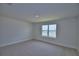 Bedroom features neutral carpet and a window at 4676 Grandview Glen Dr, Auburndale, FL 33823