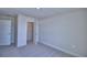 An empty bedroom with a walk-in closet featuring neutral walls and carpeted floors at 4676 Grandview Glen Dr, Auburndale, FL 33823