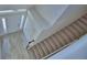 Aerial shot of entryway with carpeted staircase and wood-look tile flooring at 4676 Grandview Glen Dr, Auburndale, FL 33823