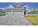 Beautiful two-story home featuring a paved driveway and well-manicured lawn at 4676 Grandview Glen Dr, Auburndale, FL 33823
