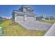 Attractive two-story home showcasing a three-car garage and green lawn at 4676 Grandview Glen Dr, Auburndale, FL 33823