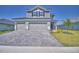Beautiful two-story home with a three-car garage and a paver driveway at 4676 Grandview Glen Dr, Auburndale, FL 33823