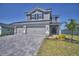 Inviting two-story home with a three-car garage and beautifully landscaped front yard at 4676 Grandview Glen Dr, Auburndale, FL 33823