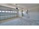 Spacious three-car garage with a clean concrete floor and ample room for vehicles at 4676 Grandview Glen Dr, Auburndale, FL 33823