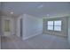 Hallway with neutral walls and carpeted floors leading to bedrooms at 4676 Grandview Glen Dr, Auburndale, FL 33823