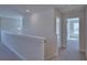 Upstairs hallway with carpet, white trim, and doors leading to bedrooms at 4676 Grandview Glen Dr, Auburndale, FL 33823