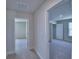 Hallway offers easy access to bedrooms with neutral carpeting at 4676 Grandview Glen Dr, Auburndale, FL 33823