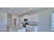 Bright kitchen showcasing white cabinets, granite countertops, and stainless steel appliances at 4676 Grandview Glen Dr, Auburndale, FL 33823