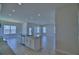 This kitchen has a center island with granite countertops overlooking a spacious living area at 4676 Grandview Glen Dr, Auburndale, FL 33823