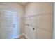 This laundry room features a metal shelving unit and light beige colored walls at 4676 Grandview Glen Dr, Auburndale, FL 33823