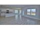 Open-concept living area with kitchen view, tile flooring, and bright natural light at 4676 Grandview Glen Dr, Auburndale, FL 33823