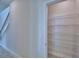 The walk-in pantry features multiple levels of metal shelving, suitable for food or storage at 4676 Grandview Glen Dr, Auburndale, FL 33823