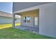 Covered patio featuring brick pavers, a neutral exterior, and access to the home and backyard at 4676 Grandview Glen Dr, Auburndale, FL 33823