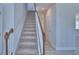 Carpeted staircase with wood railing leading to the upper level of the home at 4676 Grandview Glen Dr, Auburndale, FL 33823
