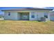 Backyard view of the home and patio with air conditioning unit at 4687 Grandview Glen Dr, Auburndale, FL 33823