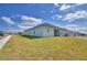 Wide exterior view of the backyard and covered patio of the home at 4687 Grandview Glen Dr, Auburndale, FL 33823
