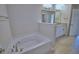 Relaxing bathroom showcasing a soaking tub with modern fixtures and tiled flooring at 4687 Grandview Glen Dr, Auburndale, FL 33823
