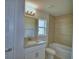 Bathroom featuring a single sink with granite counters, a large mirror and a bathtub with tile surround at 4687 Grandview Glen Dr, Auburndale, FL 33823