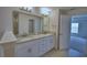 Bright bathroom featuring a double vanity with granite countertops and tile flooring at 4687 Grandview Glen Dr, Auburndale, FL 33823