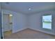 Bedroom featuring neutral carpet, white trim and walls and a double hung window for natural light at 4687 Grandview Glen Dr, Auburndale, FL 33823