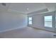 Bright bedroom with large windows and a tray ceiling providing plenty of natural light at 4687 Grandview Glen Dr, Auburndale, FL 33823