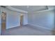 Spacious primary bedroom with tray ceiling and neutral carpeting at 4687 Grandview Glen Dr, Auburndale, FL 33823