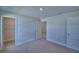 Bedroom featuring neutral carpet, white trim, paneled doors and an open closet with wire shelving at 4687 Grandview Glen Dr, Auburndale, FL 33823