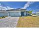 Charming single-story home with a paver driveway, attached two-car garage and a well-maintained lawn at 4687 Grandview Glen Dr, Auburndale, FL 33823