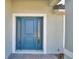 Exterior view of a blue front door with sidelights at 4687 Grandview Glen Dr, Auburndale, FL 33823