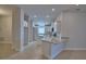 Open kitchen view with island, granite countertops, stainless appliances, and white cabinets at 4687 Grandview Glen Dr, Auburndale, FL 33823