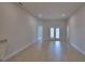 Bright living room with tiled floors and access to a patio through glass doors at 4687 Grandview Glen Dr, Auburndale, FL 33823