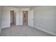 Neutral bedroom showcasing plush carpeting, a spacious layout, and a walk-in closet at 5280 Tennessee Ridge Ct, Auburndale, FL 33823