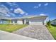 Charming single-story home with a well-manicured lawn and a paver driveway, enhancing curb appeal at 5280 Tennessee Ridge Ct, Auburndale, FL 33823