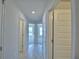 Hallway with tiled flooring, neutral paint and multiple doorways at 5280 Tennessee Ridge Ct, Auburndale, FL 33823