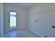 A well lit laundry room with tile flooring, washer/dryer hookups, and outdoor access at 5280 Tennessee Ridge Ct, Auburndale, FL 33823