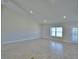 Spacious living room featuring recessed lighting, tile flooring, and a sliding glass door for outdoor access at 5280 Tennessee Ridge Ct, Auburndale, FL 33823